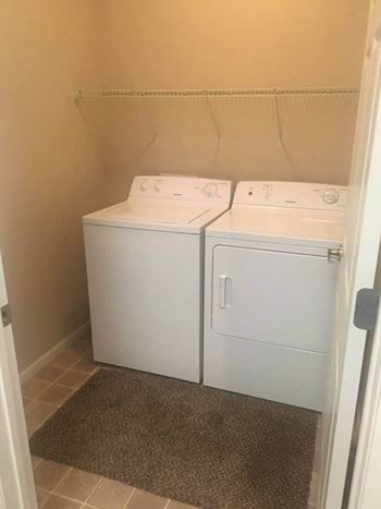 A white washer and dryer in a room
